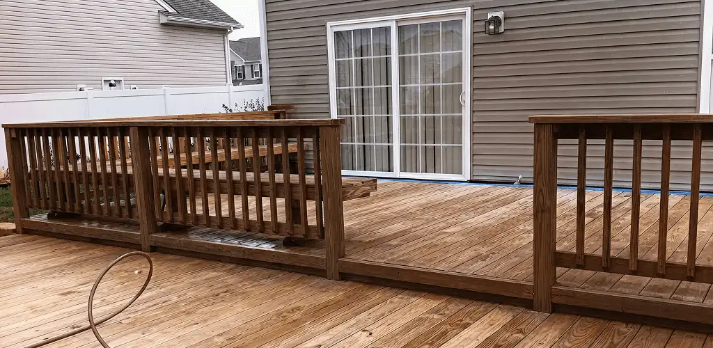 Deck sealing service protecting a backyard wood deck and railings in Grand Rapids, MI