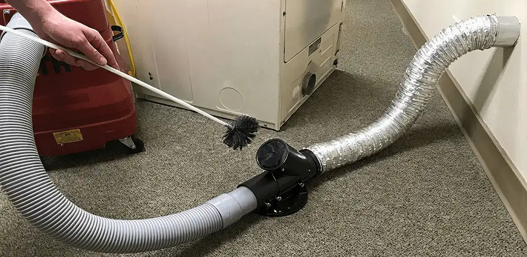 Dryer vent cleaning service removing lint from a dryer duct connection in Grand Rapids, MI
