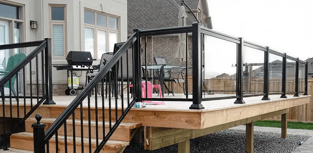 Handrail installation on a deck staircase for safety and code compliance in Grand Rapids, MI