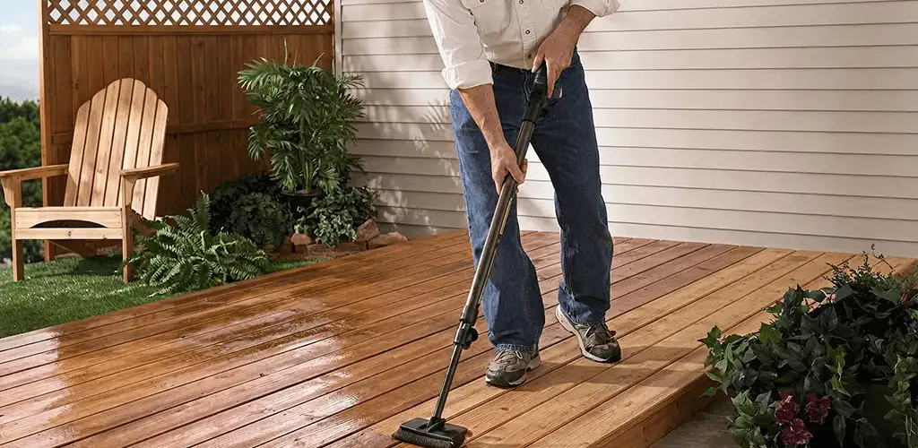 Deck staining service applying stain to a backyard wood deck in Grand Rapids, MI